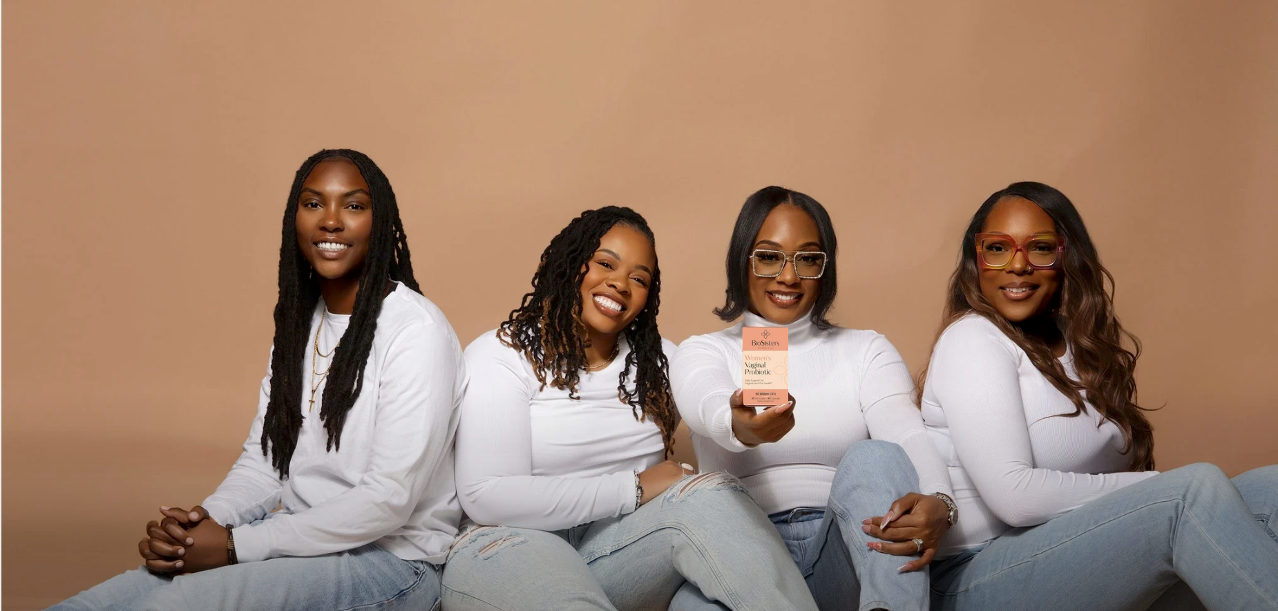 Founders of BioSisters Vitamin Care holding the daily probiotic for vaginal and gut health.
